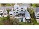 Aerial view of a modern white home featuring a backyard pool, complemented by lush landscaping at 156 Nobels Point St, Charleston, SC 29492