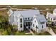 An aerial view of the property, featuring lovely landscaping, a waterway, and a metal roof at 156 Nobels Point St, Charleston, SC 29492