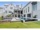Lush backyard with a pool, patio, and outdoor kitchen perfect for entertaining in this modern home at 156 Nobels Point St, Charleston, SC 29492