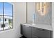 Modern bathroom featuring black vanity, mosaic tile accent wall, and a large picture window at 156 Nobels Point St, Charleston, SC 29492