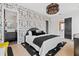 Stylish bedroom featuring patterned wallpaper, modern lighting, and ensuite bathroom entrance at 156 Nobels Point St, Charleston, SC 29492