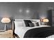 Close up of an elegant bedroom featuring textured accent wall, neutral color palette, and modern lighting at 156 Nobels Point St, Charleston, SC 29492