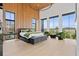 Spacious bedroom with floor to ceiling windows, wood paneled walls, and stylish furniture creating a serene atmosphere at 156 Nobels Point St, Charleston, SC 29492