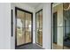 Modern entryway showcasing black framed glass doors offering views of the kitchen and outdoor scenery at 156 Nobels Point St, Charleston, SC 29492