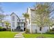 Manicured front yard featuring a modern home with stone walkway, grass and professional landscaping at 156 Nobels Point St, Charleston, SC 29492