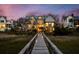 Luxury home with exterior night view, featuring a wooden walkway, and beautiful landscaping at 156 Nobels Point St, Charleston, SC 29492