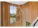 Stairwell featuring a modern chandelier, high ceilings, wood paneling, and a large window with a neighborhood view at 156 Nobels Point St, Charleston, SC 29492