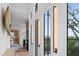 Bright foyer showcases large windows, modern light fixtures, and neutral decor with stairs leading up at 156 Nobels Point St, Charleston, SC 29492