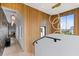Hallway with modern lighting, wood paneled accent wall, staircase and bright views from the windows at 156 Nobels Point St, Charleston, SC 29492