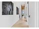 Minimalist hallway features white walls, geometric artwork, and wood floors leading to a bright living space at 156 Nobels Point St, Charleston, SC 29492