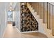 Bright hallway featuring wood floors, unique wallpaper, and modern light fixtures leading to staircase at 156 Nobels Point St, Charleston, SC 29492