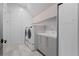 Modern laundry room featuring white cabinets, sink, and updated appliances at 156 Nobels Point St, Charleston, SC 29492