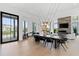 Bright, open-concept living and dining area with modern lighting, fireplace, and large windows at 156 Nobels Point St, Charleston, SC 29492