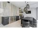The outdoor kitchen features a built-in grill, modern cabinetry, and a dining area under stylish pendant lights at 156 Nobels Point St, Charleston, SC 29492