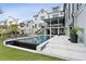 Backyard view of a modern home featuring a swimming pool, grassy area, and inviting patio at 156 Nobels Point St, Charleston, SC 29492