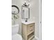 Charming bathroom with wood vanity, quartz countertop, modern faucet, decorative mirror, and updated light fixture at 16 Oatly Cir, Charleston, SC 29414