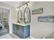 Stylish bathroom with double vanity, decorative mirrors, and herringbone flooring at 16 Oatly Cir, Charleston, SC 29414