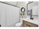 Bright bathroom featuring modern vanity, framed mirror, beach-themed art, and shower with white curtain at 16 Oatly Cir, Charleston, SC 29414