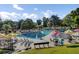 Community pool with lounge chairs, umbrellas, landscaping, and blue sky creates an inviting outdoor oasis at 16 Oatly Cir, Charleston, SC 29414