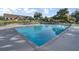 Large community pool with clear blue water, surrounded by lounge chairs and umbrellas for relaxation in the sun at 16 Oatly Cir, Charleston, SC 29414