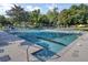 Large swimming pool lined with blue and white pennant flags, lounge chairs, and green trees at 16 Oatly Cir, Charleston, SC 29414