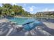 Resort-style community pool with diving blocks and flags, surrounded by lush landscaping and clear blue skies at 16 Oatly Cir, Charleston, SC 29414