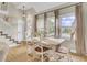 Charming dining area with vaulted ceiling, featuring a white dining table and staircase at 16 Oatly Cir, Charleston, SC 29414