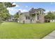 Charming home with large front lawn, white picket fence, columned porch, and mature trees at 16 Oatly Cir, Charleston, SC 29414