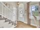 Bright foyer features natural light, a decorative front door, and stairs to the second story at 16 Oatly Cir, Charleston, SC 29414