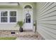 Inviting front entrance with charming front door, brick steps, and manicured landscaping at 16 Oatly Cir, Charleston, SC 29414