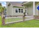 Inviting home exterior featuring a front porch with white picket fence and lush green lawn at 16 Oatly Cir, Charleston, SC 29414