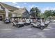 Group of golf carts parked outside a community clubhouse on a sunny day at 16 Oatly Cir, Charleston, SC 29414