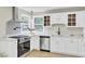 Stylish kitchen features white cabinets, stainless steel appliances, and quartz countertops at 16 Oatly Cir, Charleston, SC 29414