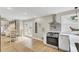 Open kitchen and dining area featuring stainless steel appliances, hardwood floors, and modern lighting at 16 Oatly Cir, Charleston, SC 29414