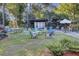 Charming outdoor area with multiple seating arrangements surrounded by lush landscaping at 16 Oatly Cir, Charleston, SC 29414