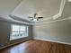 Bedroom with trey ceiling, window, and wood floor at 1705 Falcon Cove Ln, Hanahan, SC 29410