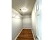 Bright closet space with wood-look floors and metal shelving for organized storage at 1705 Falcon Cove Ln, Hanahan, SC 29410