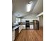 Efficient kitchen features stainless steel appliances, white cabinets, and wood floors for a stylish look at 1705 Falcon Cove Ln, Hanahan, SC 29410