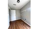 Practical laundry room with wood floors, a utility sink connection, and storage shelving above at 1705 Falcon Cove Ln, Hanahan, SC 29410