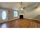 Bright living room with wood floors, fireplace, ceiling fan, and entry door with decorative glass at 1705 Falcon Cove Ln, Hanahan, SC 29410