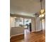 Living room showcasing wood floors, an open layout, and a view into the adjacent kitchen with modern appliances at 1705 Falcon Cove Ln, Hanahan, SC 29410
