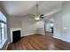 Inviting living room with wood floors, fireplace, ceiling fan, and an open layout leading to the kitchen at 1705 Falcon Cove Ln, Hanahan, SC 29410