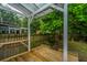 Shaded backyard patio features built-in benches and a wooden fence; an outdoor retreat at 173 Fishburne St, Charleston, SC 29403