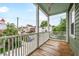 The covered balcony is great for entertaining and relaxing outdoors; community views in background at 173 Fishburne St, Charleston, SC 29403