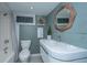Well lit bathroom featuring a tub and shower, commode, basin sink, wood trimmed mirror, and stylish decor at 173 Fishburne St, Charleston, SC 29403