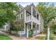 Charming two-story home with double porches, complemented by mature trees and a well-manicured lawn at 173 Fishburne St, Charleston, SC 29403