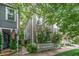 Charming two-story home with a white picket fence, surrounded by lush greenery and an American flag at 173 Fishburne St, Charleston, SC 29403