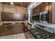 Kitchen with wood accents, dark cabinetry, stainless steel appliances, and granite countertops at 173 Fishburne St, Charleston, SC 29403