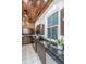Kitchen with dark cabinets, stainless steel appliances, granite countertops, and exposed brick at 173 Fishburne St, Charleston, SC 29403