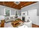 Spacious living room with a wooden ceiling, fireplace, and stylish furniture at 173 Fishburne St, Charleston, SC 29403